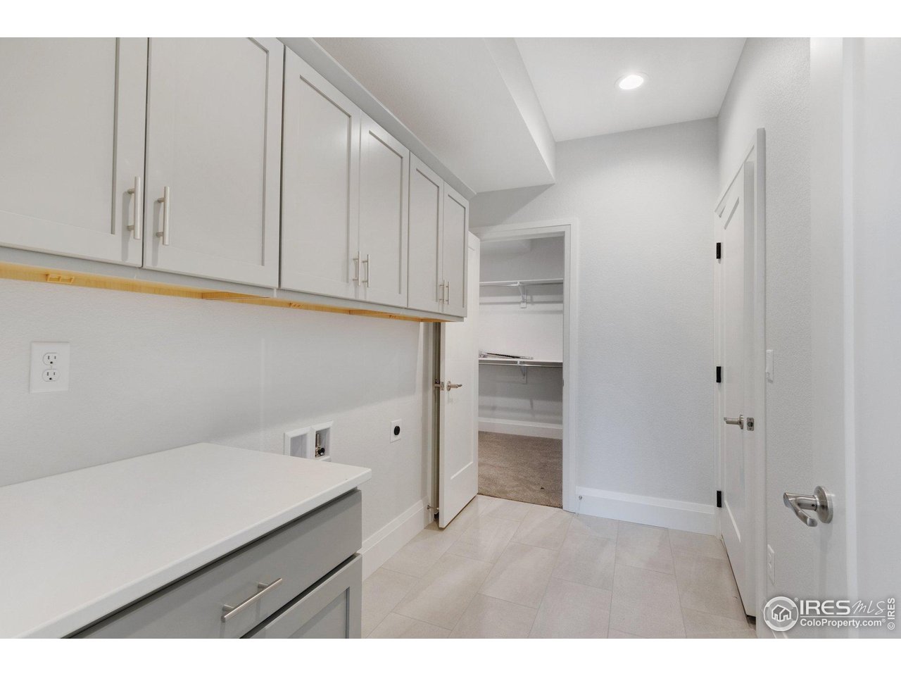 5700 2nd Road Greeley, CO 80634 - Photo 25 of 40 A convenient "drop-zone" mudroom right off the garage, with plenty of storage & a coat closet, plus access to the primary closet!