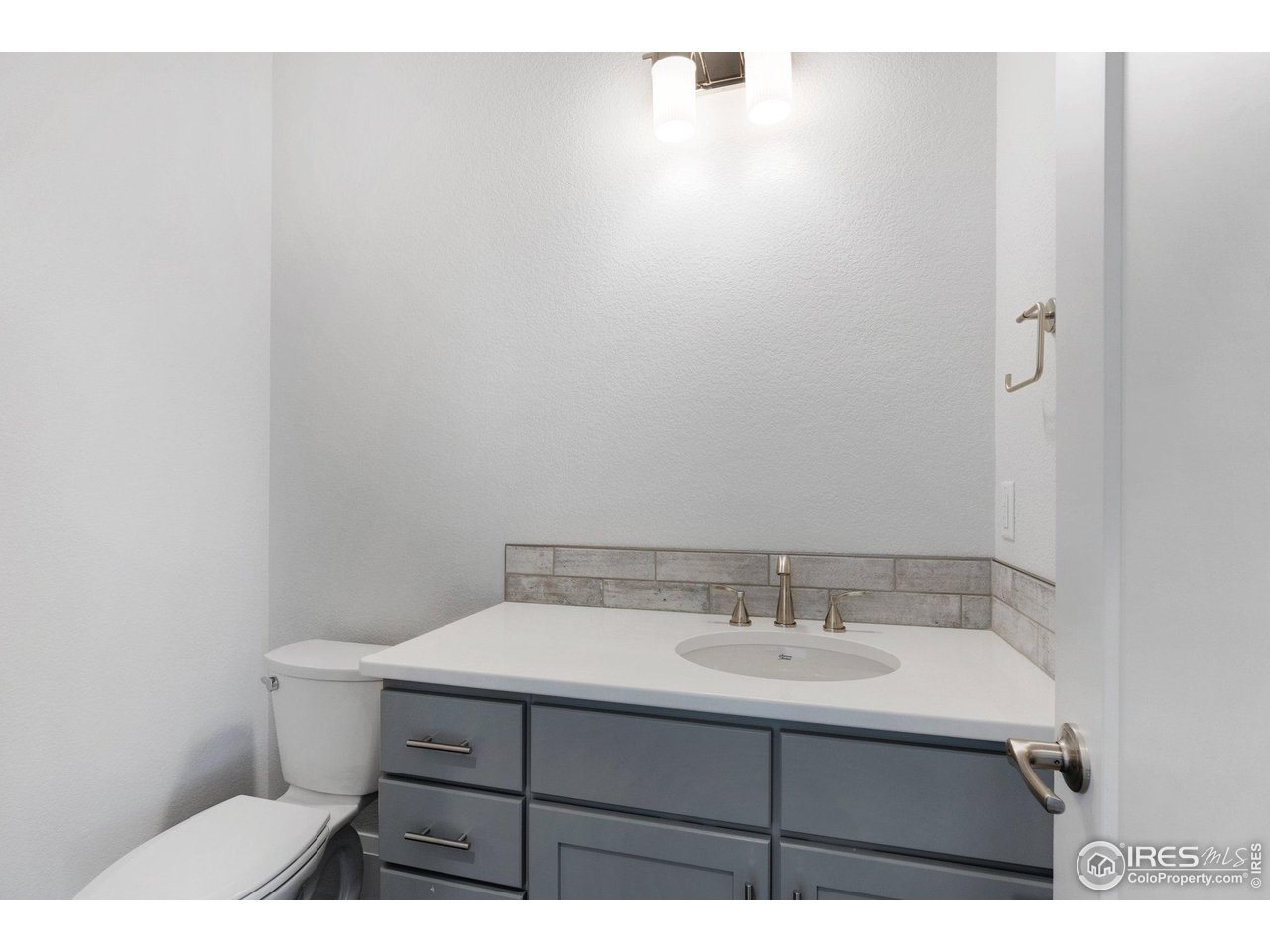 5700 2nd Road Greeley, CO 80634 - Photo 8 of 40 A convenient powder bath right by the front entryway and the office up front