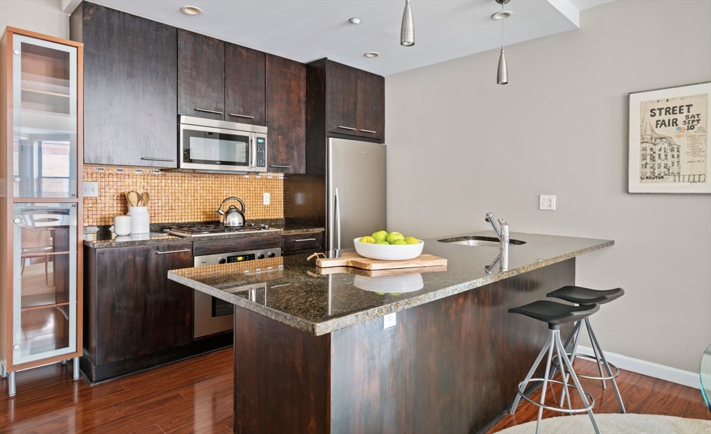 35 Fay Street, Unit 215 Boston, MA 02118 - Photo 6 of 14 a kitchen with stainless steel appliances granite countertop a sink a stove and refrigerator