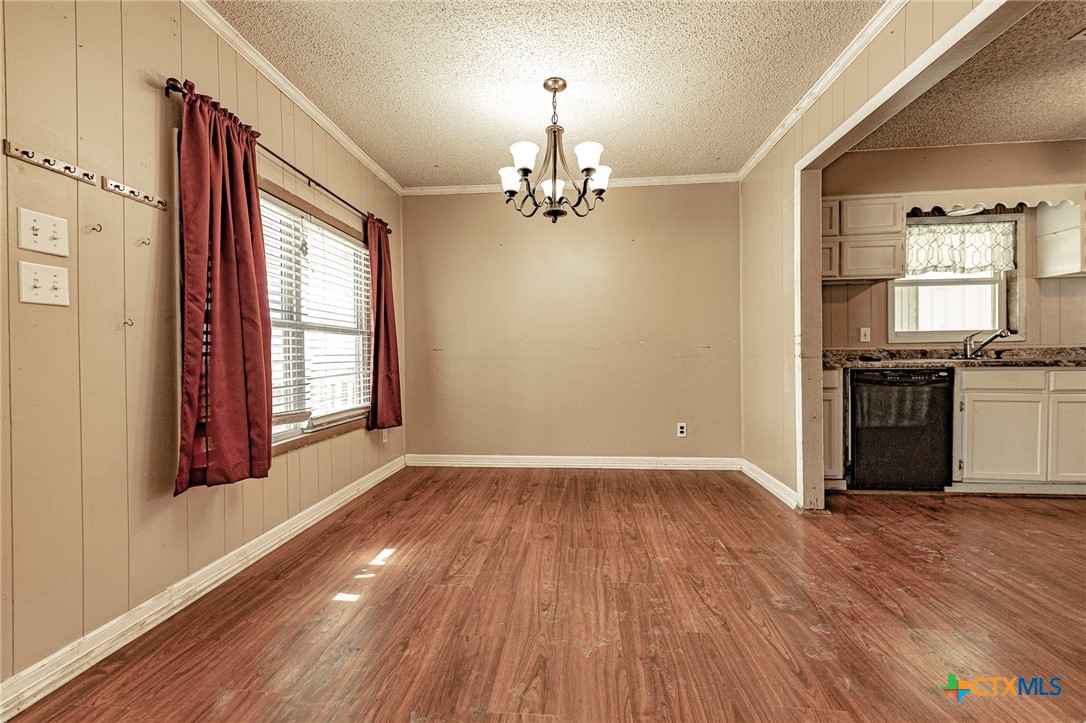 3300 State Highway 95 Shiner, TX 77984 - Photo 11 of 26 an empty room with wooden floor cabinet and windows