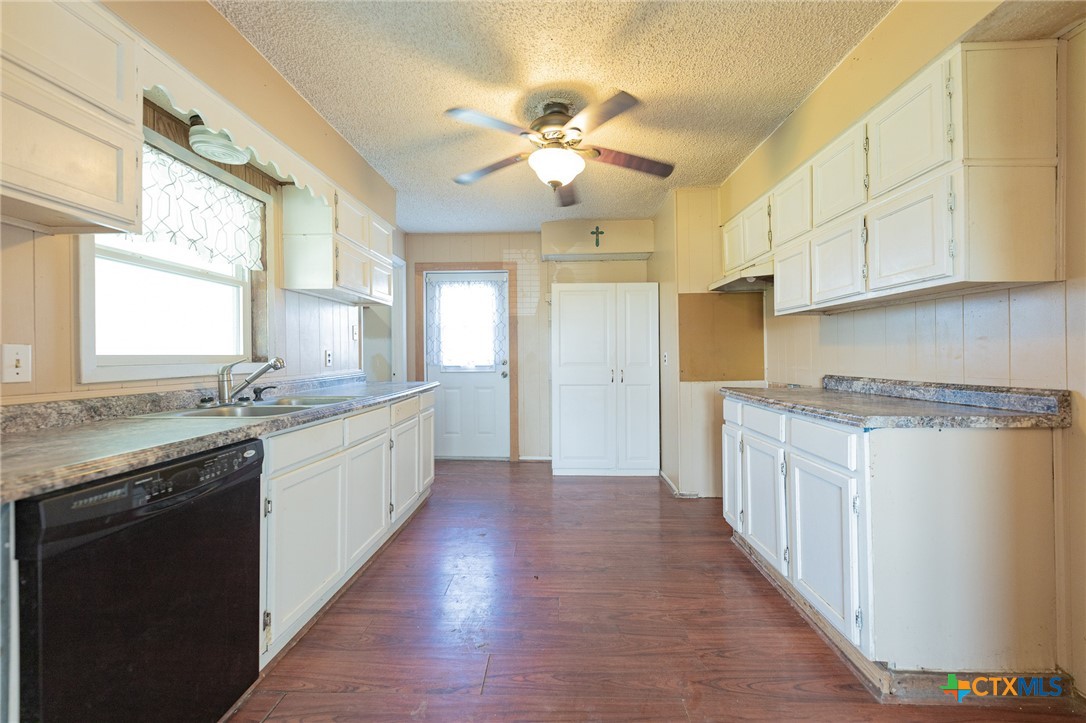 3300 State Highway 95 Shiner, TX 77984 - Photo 12 of 26 a large kitchen with stainless steel appliances granite countertop a lot of counter space and wooden floors