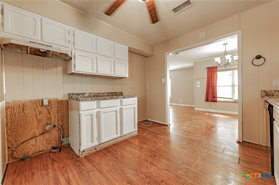 3300 State Highway 95 Shiner, TX 77984 - Photo 13 of 26 a kitchen with granite countertop white cabinets and white appliances