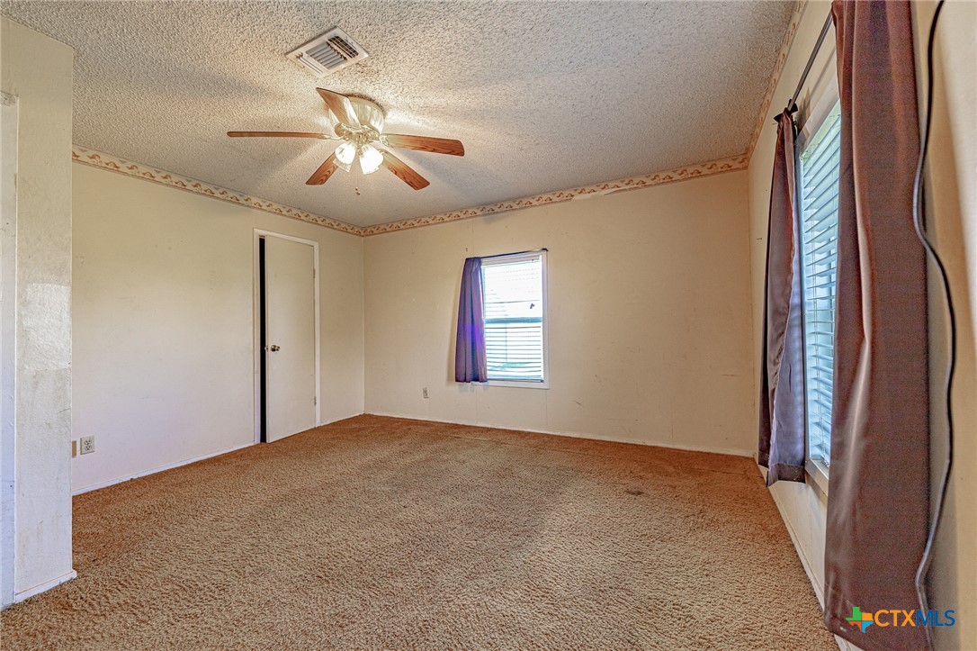 3300 State Highway 95 Shiner, TX 77984 - Photo 16 of 26 wooden floor in an empty room with a window