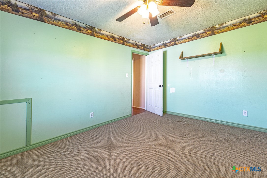 3300 State Highway 95 Shiner, TX 77984 - Photo 20 of 26 an empty room with a ceiling fan
