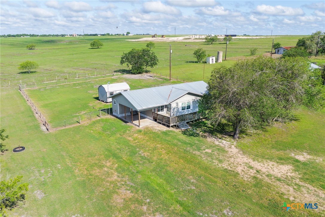 3300 State Highway 95 Shiner, TX 77984 - Photo 4 of 26 an aerial view of a house with a yard and lake view
