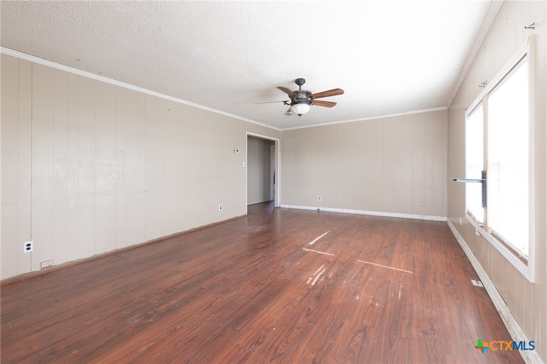 3300 State Highway 95 Shiner, TX 77984 - Photo 9 of 26 wooden floor in an empty room with a window