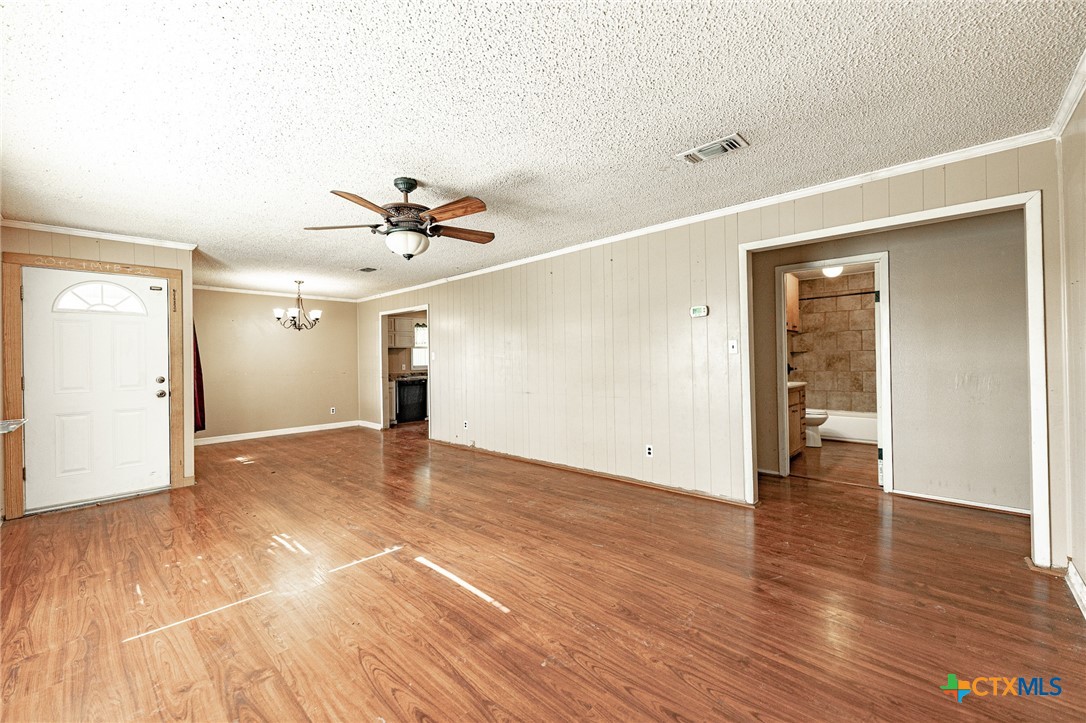 3300 State Highway 95 Shiner, TX 77984 - Photo 10 of 26 a view of empty room with wooden floor and ceiling fan