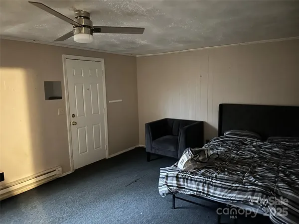 a bedroom with a bed and a chair