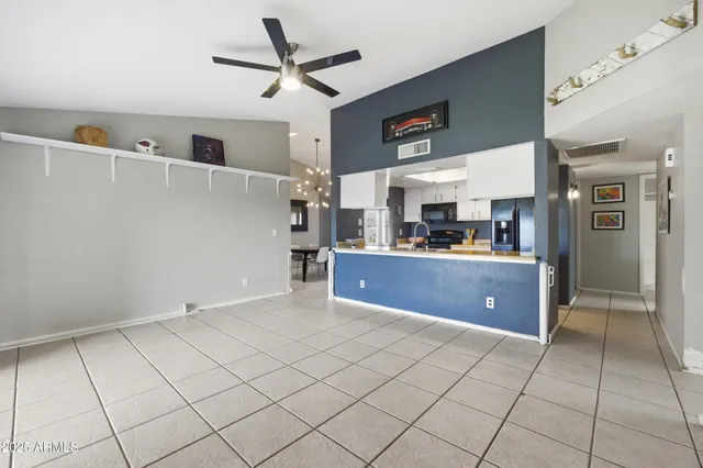 a view of kitchen with furniture and refrigerator