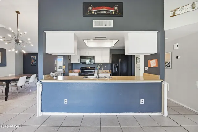 a living room with couches and a kitchen view
