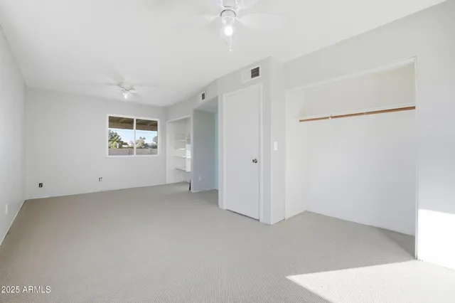 an empty room with a empty space and windows