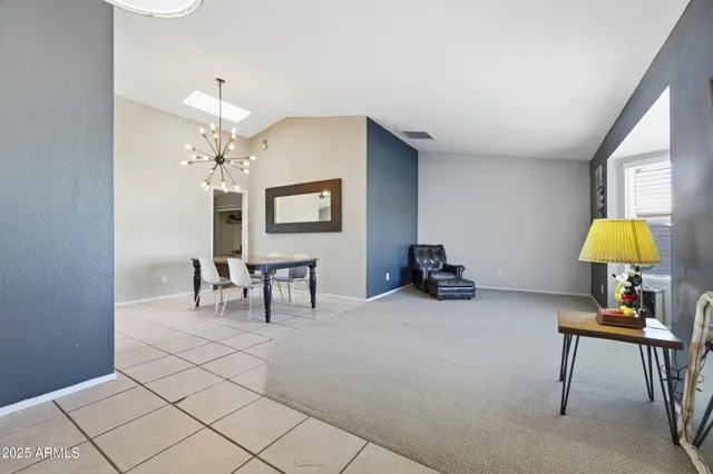 a living room with furniture and a lamp