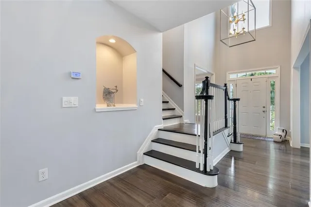 a living room with furniture a flat screen tv and kitchen view