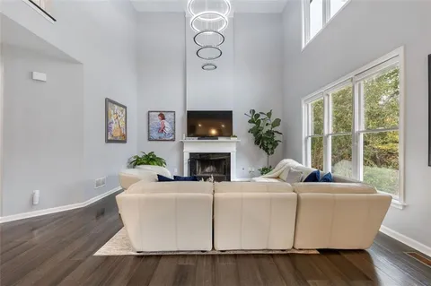 a kitchen with stainless steel appliances kitchen island a refrigerator sink and white cabinets