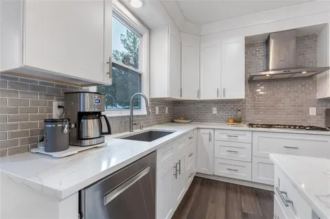 a large white bed sitting in a room next to a window