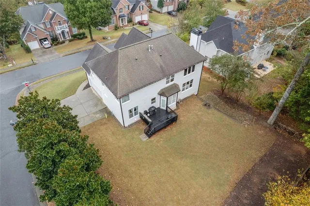 a living room with furniture and a view of kitchen