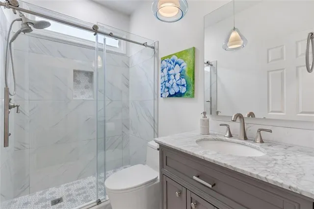 an aerial view of residential houses with outdoor space and parking