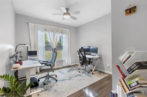 a picture of a room with a white wall and white refrigerator
