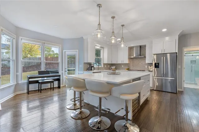 a living room with furniture a fireplace and a large window