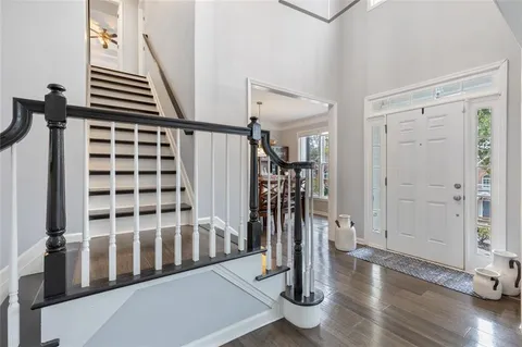 a kitchen with stainless steel appliances granite countertop a refrigerator sink and white cabinets