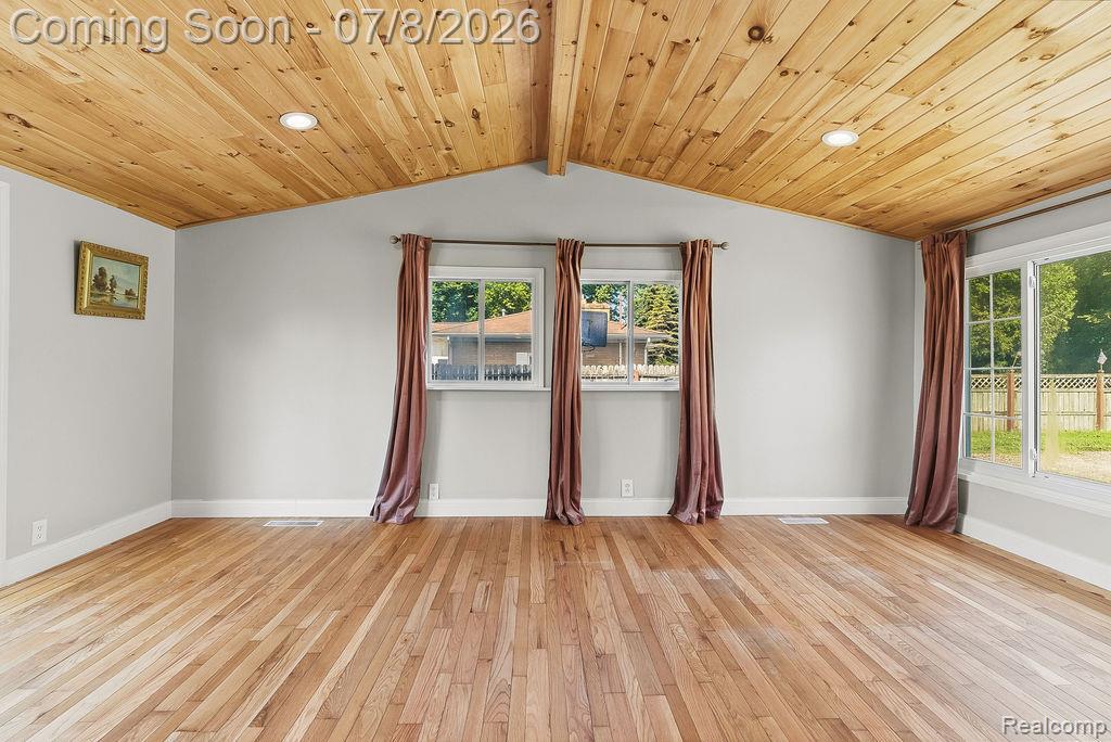 5698 McGrandy Road Bridgeport, MI 48722 - Photo 9 of 26 Vaulted wood-plank ceiling with recessed lighting, complemented by wood-finish flooring