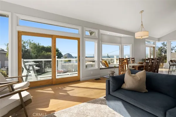 a living room with furniture and a floor to ceiling window