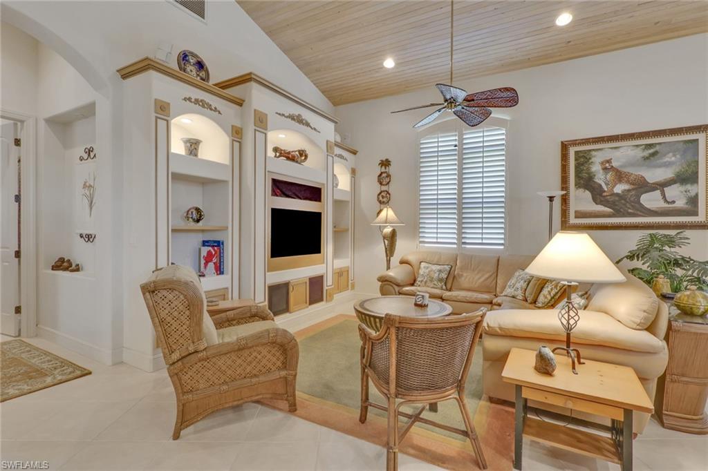 435 Terracina Way Naples, FL 34119 - Photo 15 of 50 Tiled living room featuring built in features, wood ceiling, ceiling fan, lofted ceiling, and recessed lighting