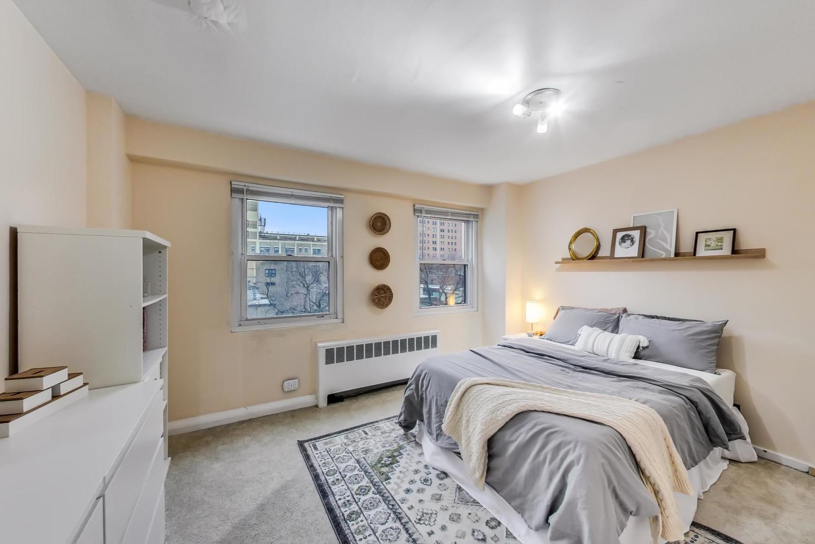 2909 North Sheridan Road, Unit 411 Chicago, IL 60657 - Photo 11 of 15 a bedroom with a bed and a window