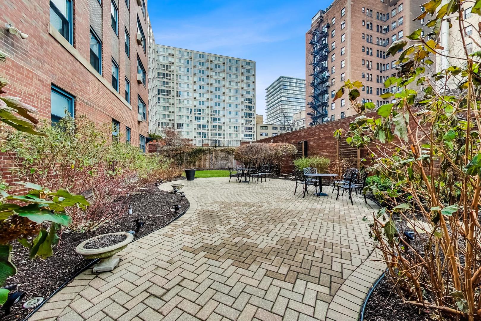 2909 North Sheridan Road, Unit 411 Chicago, IL 60657 - Photo 13 of 15 a view of a patio with plants and furniture