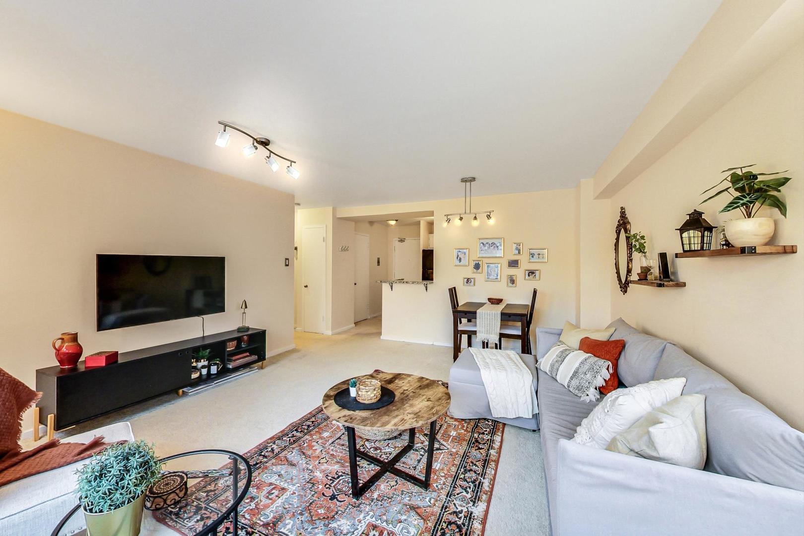 2909 North Sheridan Road, Unit 411 Chicago, IL 60657 - Photo 4 of 15 a living room with furniture and a flat screen tv
