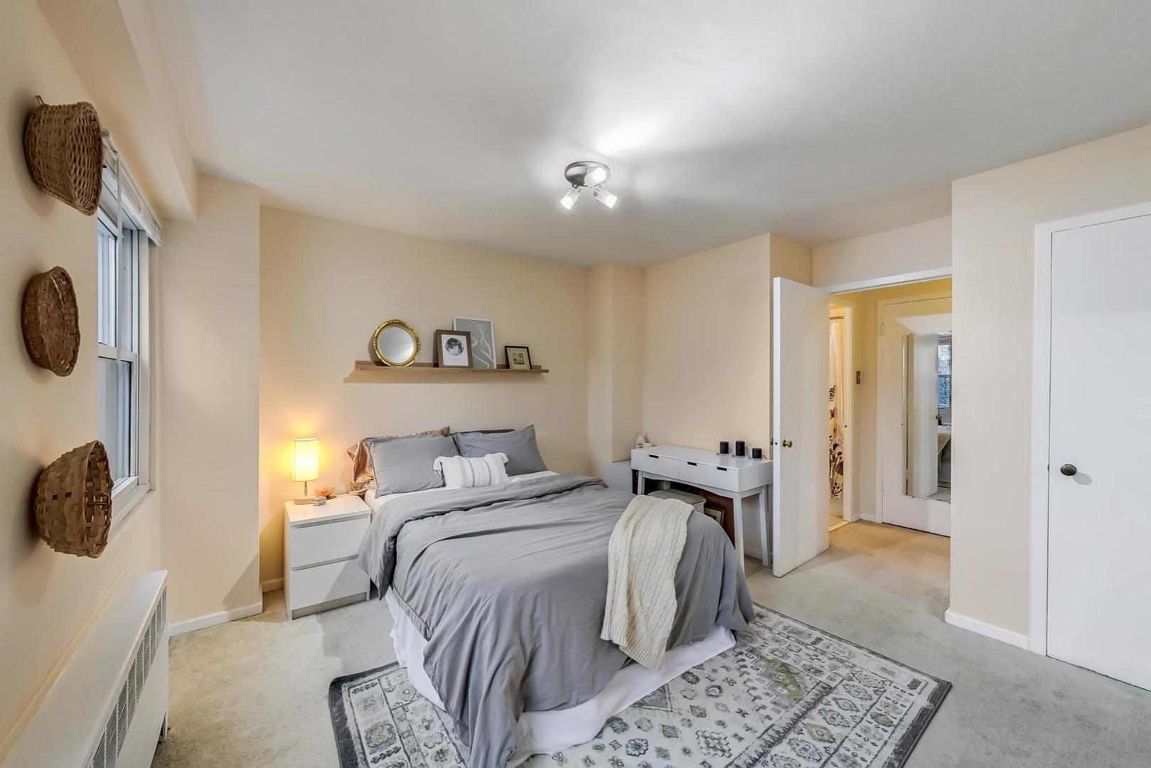 2909 North Sheridan Road, Unit 411 Chicago, IL 60657 - Photo 9 of 15 a bedroom with a bed and a chandelier