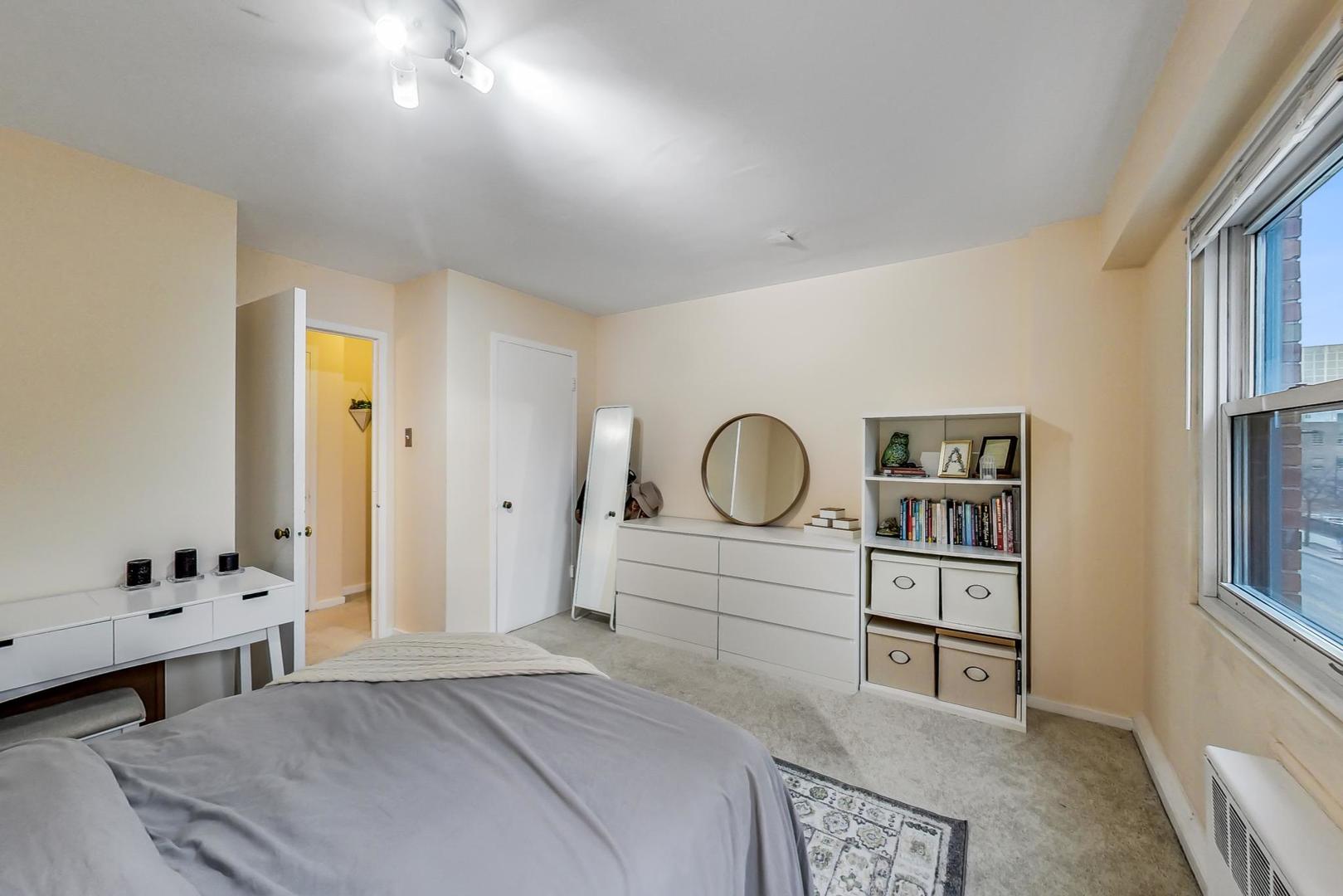 2909 North Sheridan Road, Unit 411 Chicago, IL 60657 - Photo 10 of 15 a bedroom with a bed and a window