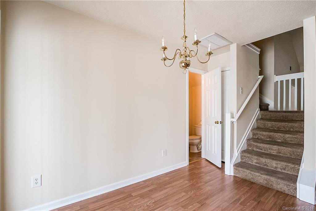 11228 Grass Field Road Charlotte, NC 28213 - Photo 13 of 26 a view of a chandelier fan and wooden floor