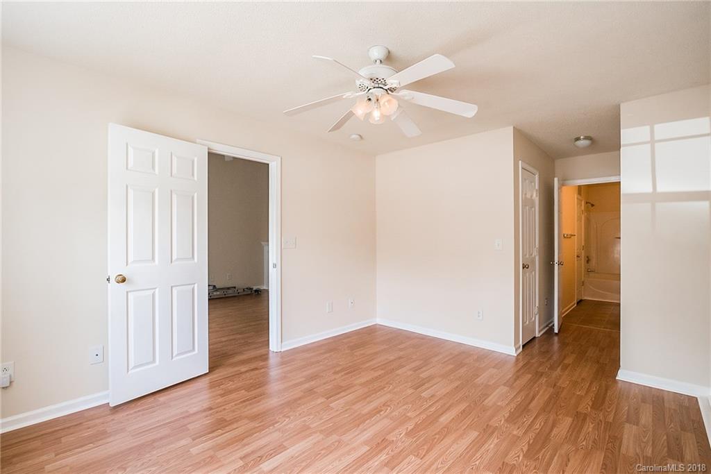 11228 Grass Field Road Charlotte, NC 28213 - Photo 14 of 26 a view of an empty room with wooden floor