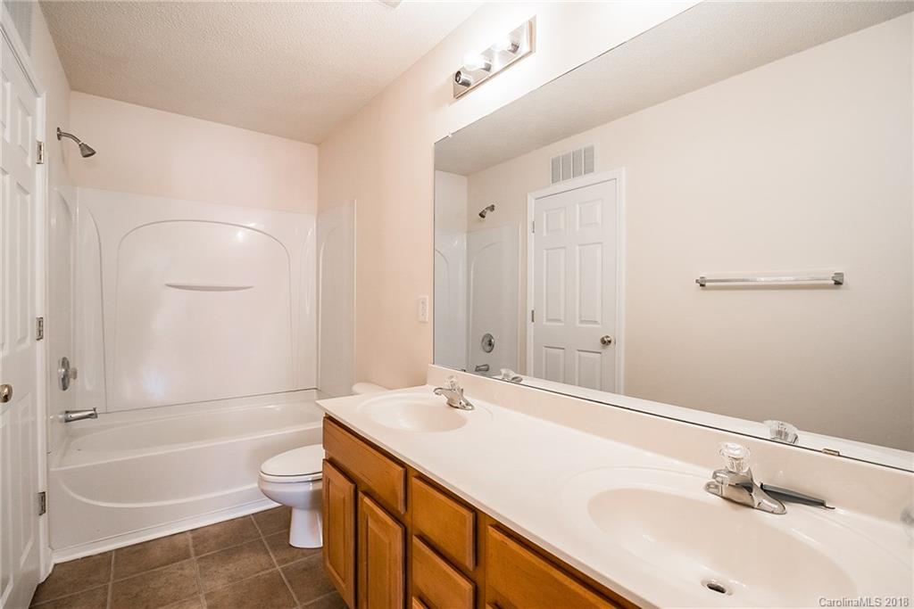 11228 Grass Field Road Charlotte, NC 28213 - Photo 17 of 26 a bathroom with a sink a toilet and shower