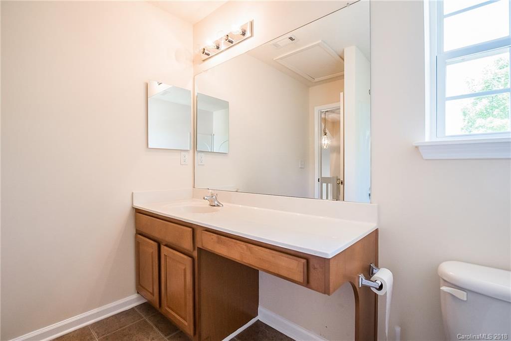 11228 Grass Field Road Charlotte, NC 28213 - Photo 21 of 26 a bathroom with a sink vanity and a toilet