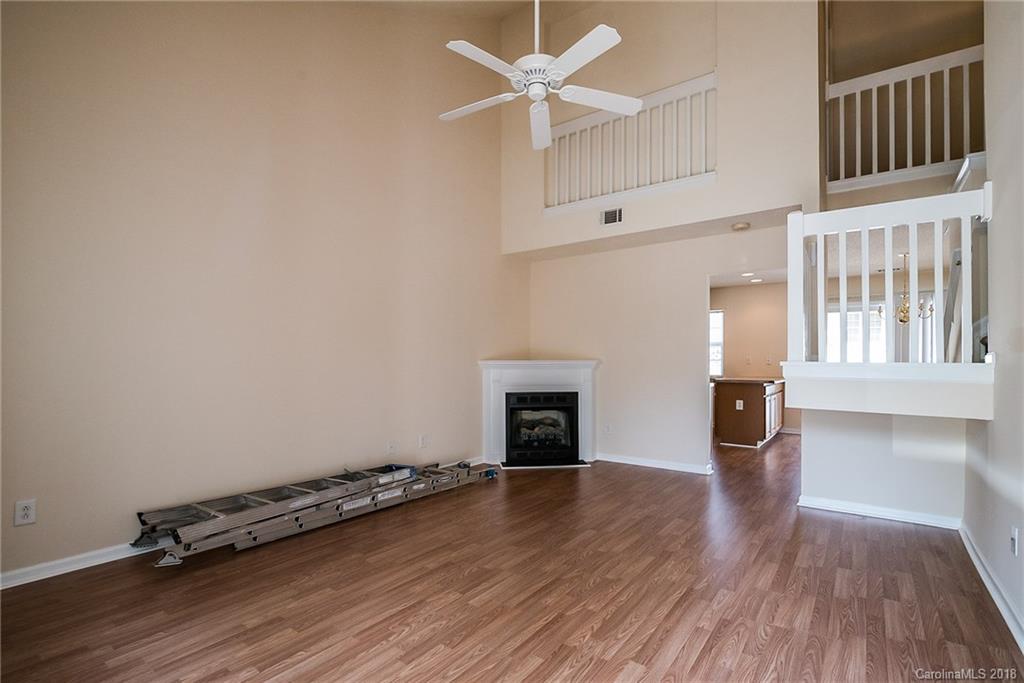 11228 Grass Field Road Charlotte, NC 28213 - Photo 4 of 26 a view of an empty room with a window and wooden floor