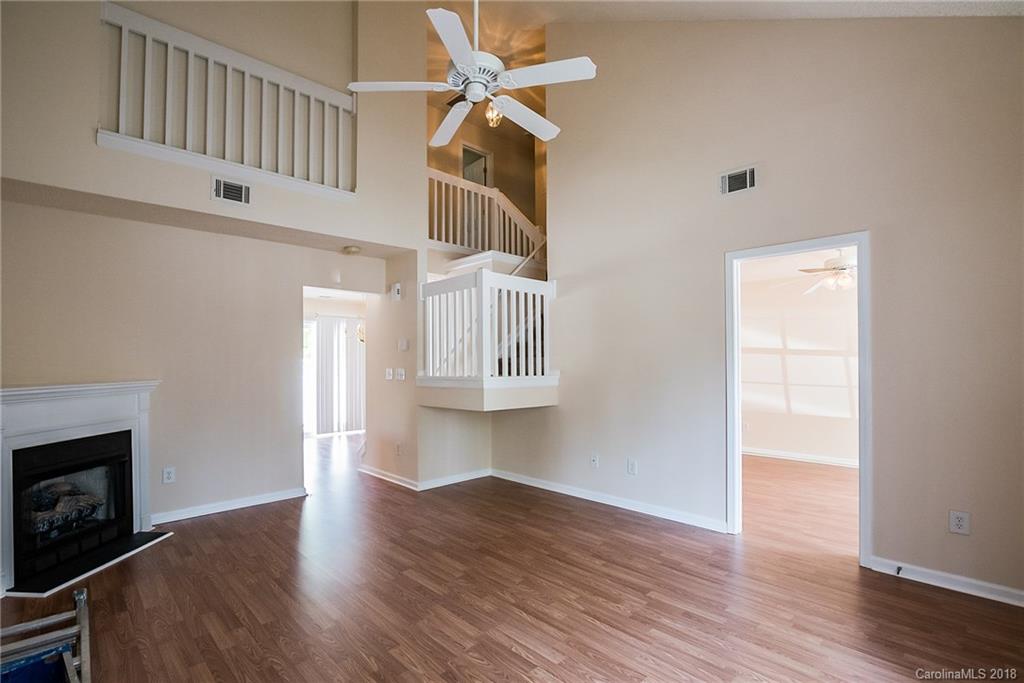11228 Grass Field Road Charlotte, NC 28213 - Photo 5 of 26 a view of an empty room with a window and wooden floor
