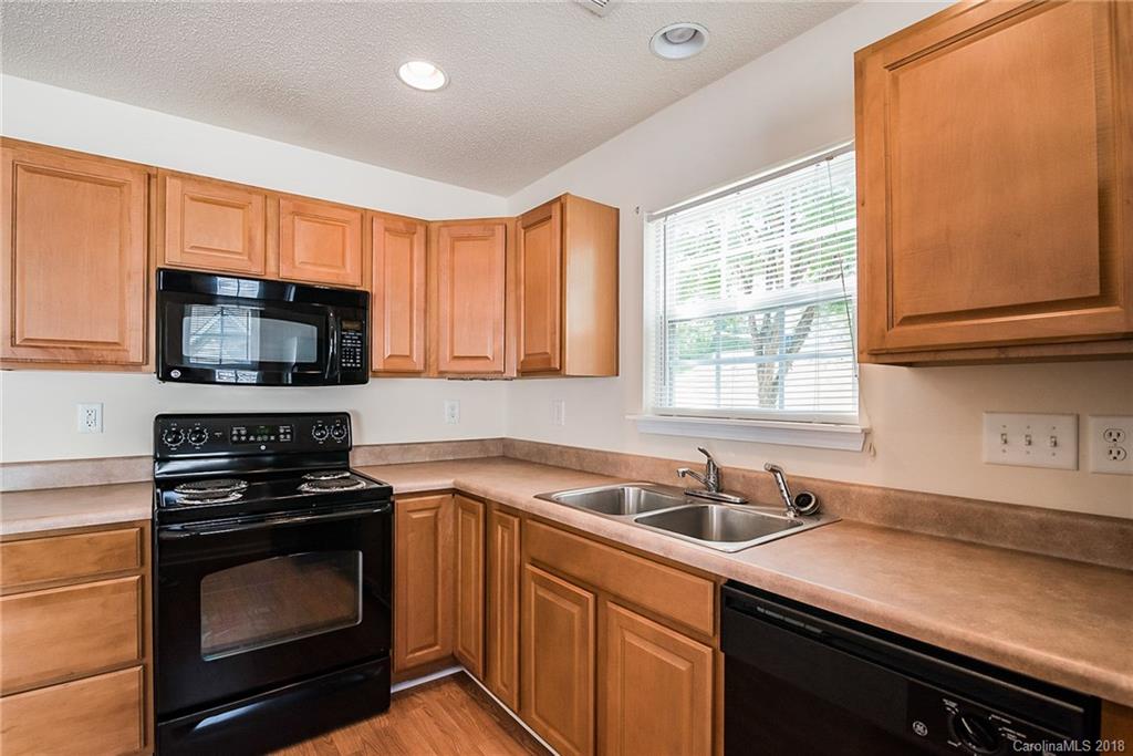 11228 Grass Field Road Charlotte, NC 28213 - Photo 10 of 26 a kitchen with stainless steel appliances a stove sink microwave and cabinets
