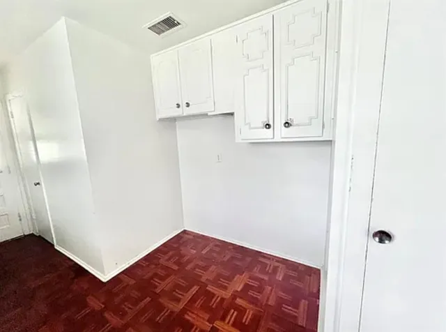 a view of an empty room and wooden floor