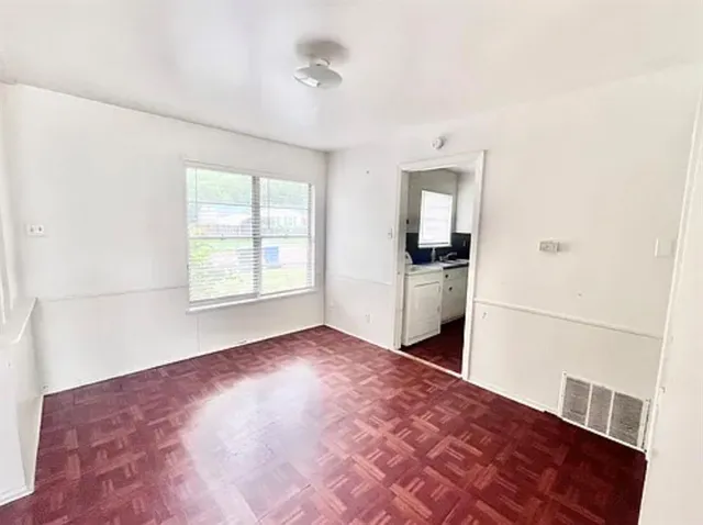 a view of a kitchen with an empty space and a window