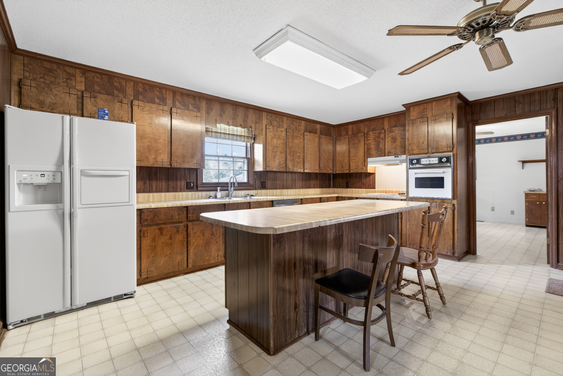 3369 Sandy Circle Macon, GA 31216 - Photo 12 of 65 a kitchen with kitchen island a cabinets counter space and appliances