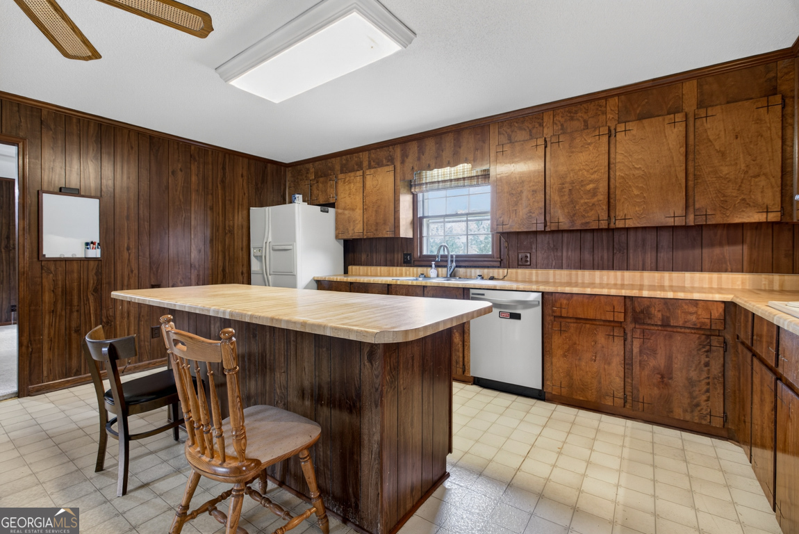 3369 Sandy Circle Macon, GA 31216 - Photo 13 of 65 a kitchen with a stove a sink and a refrigerator