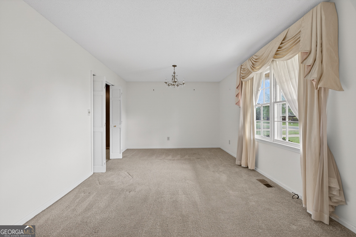 3369 Sandy Circle Macon, GA 31216 - Photo 20 of 65 an empty room with windows and chandelier fan