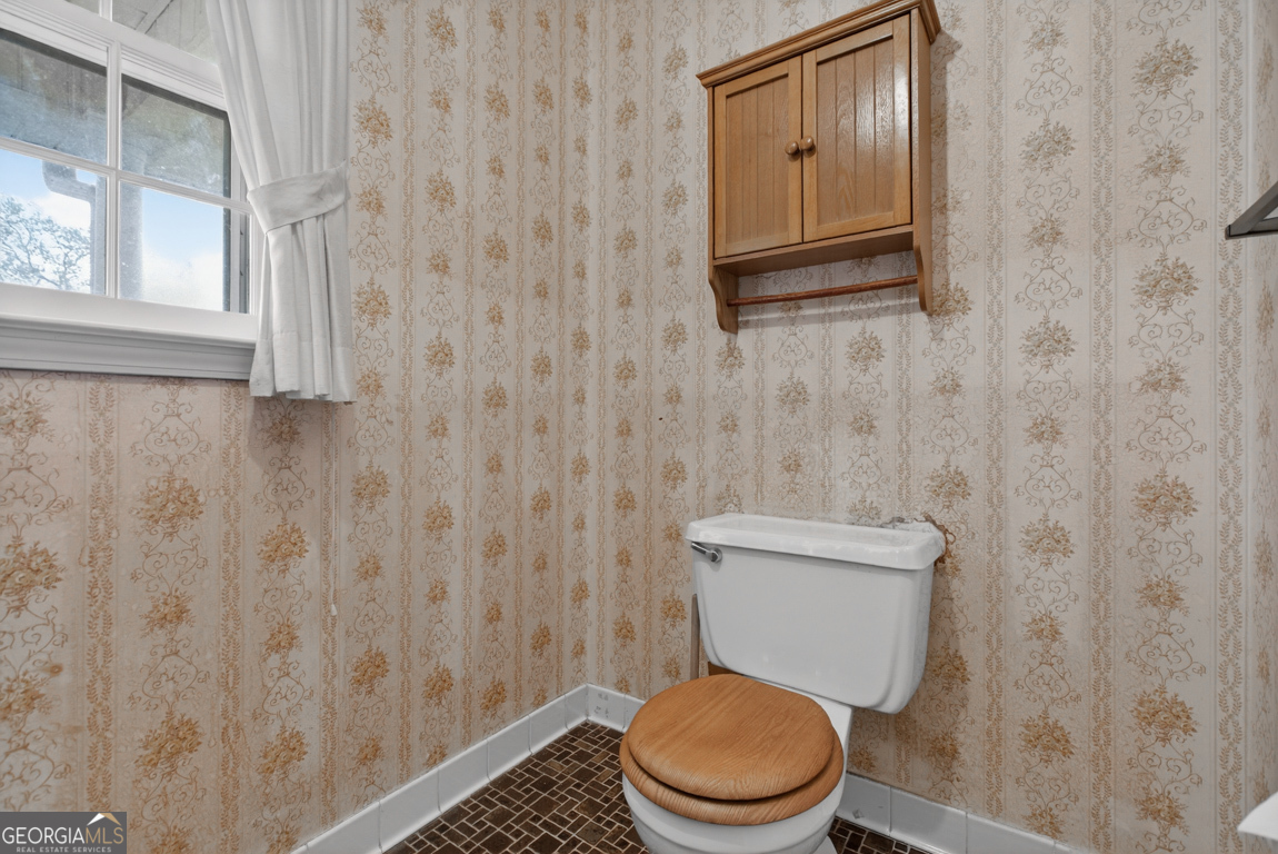 3369 Sandy Circle Macon, GA 31216 - Photo 26 of 65 a white toilet sitting next to a shower curtain