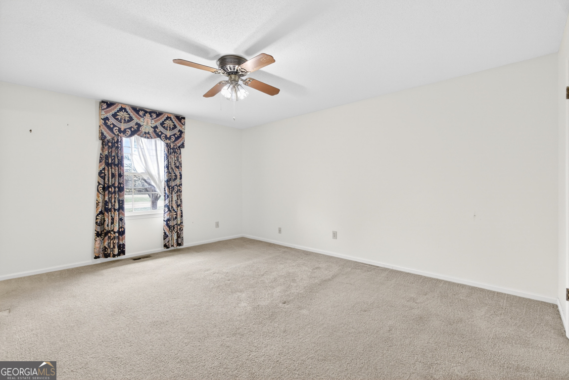 3369 Sandy Circle Macon, GA 31216 - Photo 32 of 65 an empty room with windows and fan
