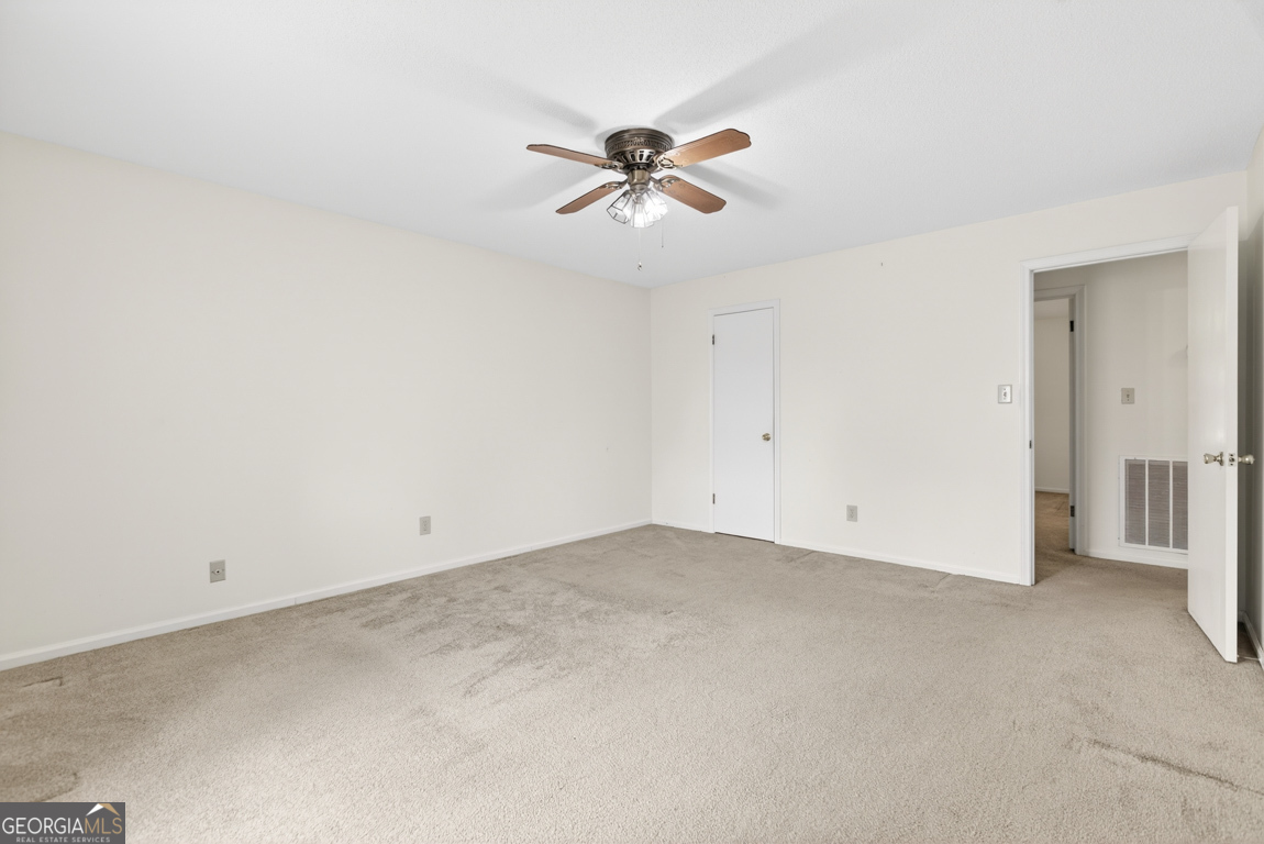 3369 Sandy Circle Macon, GA 31216 - Photo 38 of 65 an empty room with a ceiling fan and wooden floor