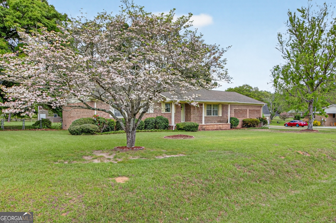 3369 Sandy Circle Macon, GA 31216 - Photo 49 of 65 a front view of a house with a garden