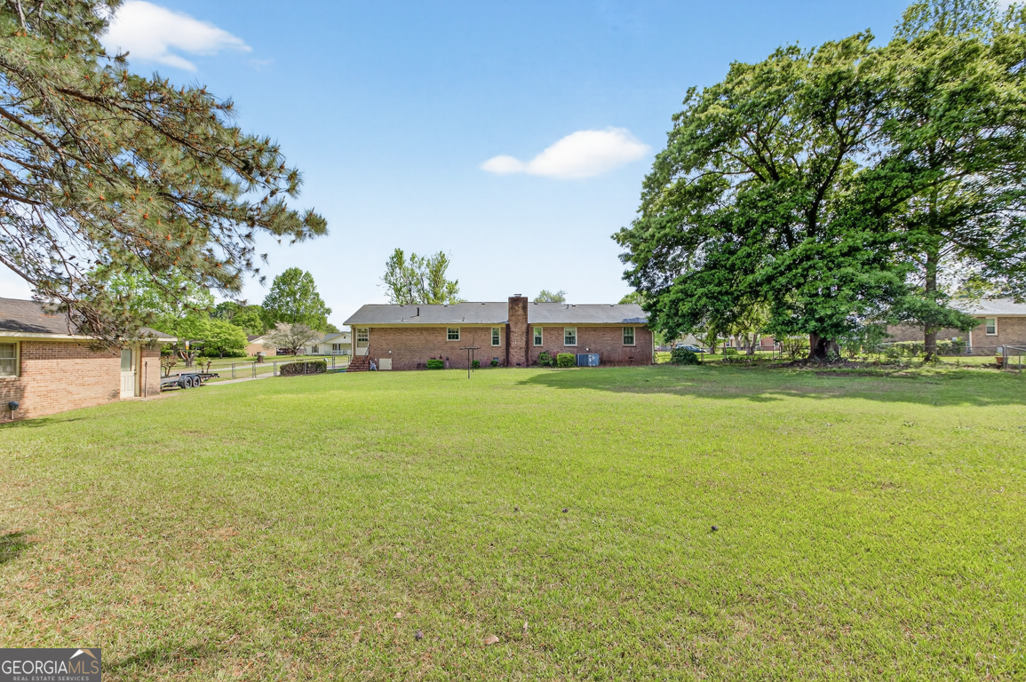3369 Sandy Circle Macon, GA 31216 - Photo 53 of 65 a view of a field of grass and trees