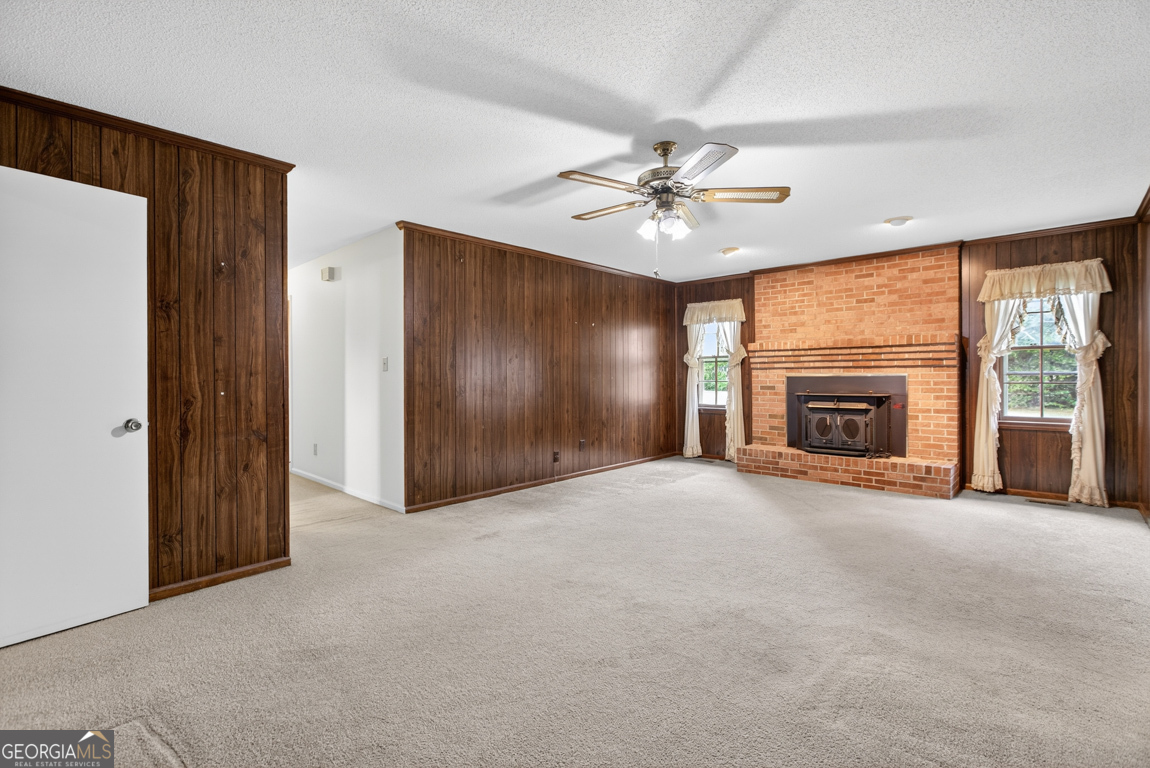 3369 Sandy Circle Macon, GA 31216 - Photo 7 of 65 an empty room with fireplace and fan